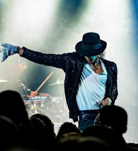 Michael Jackson impersonator dancing on stage.