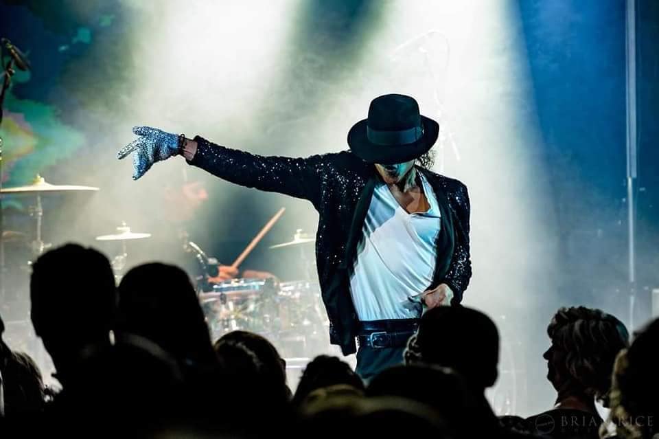 Michael Jackson impersonator dancing on stage.