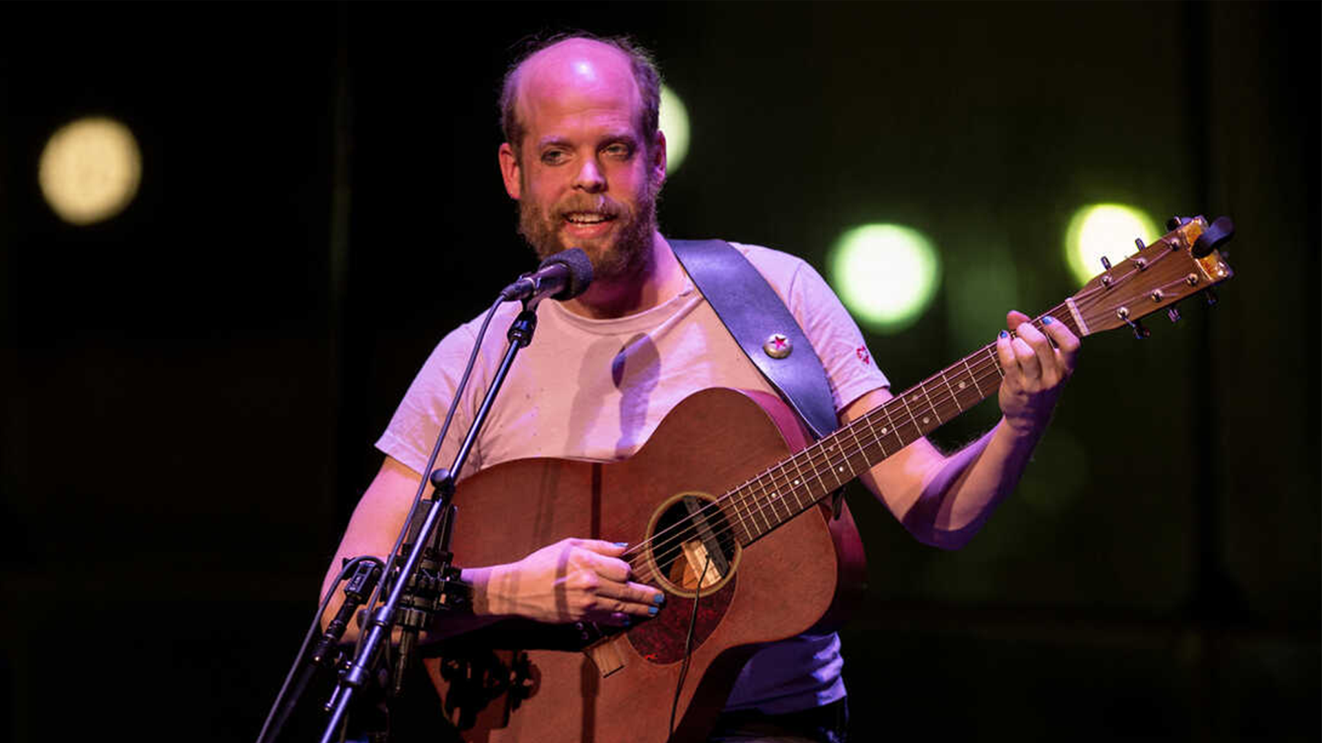 Bonnie Prince Billy playing guitar on stage